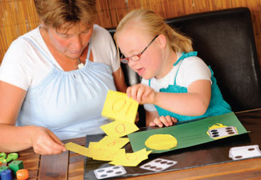 Kid playing game with caregiver