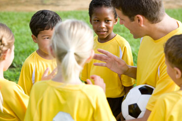 Kids Soccer Team Talking with Coach