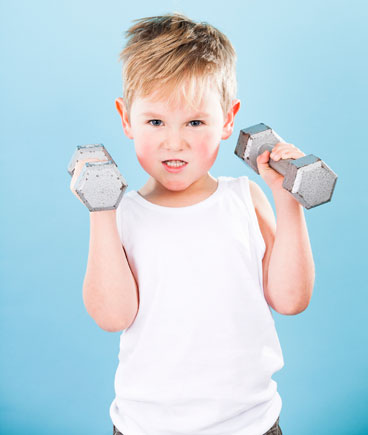 toddler boy lifting weights
